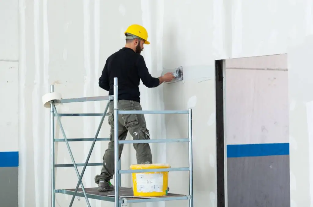 worker plastering gypsum board wall 2025 03 23 20 47 49 utc